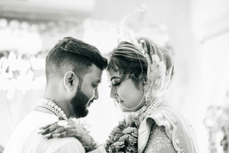 Beautiful black and white portrait of a South Asian couple in traditional wedding attire.
